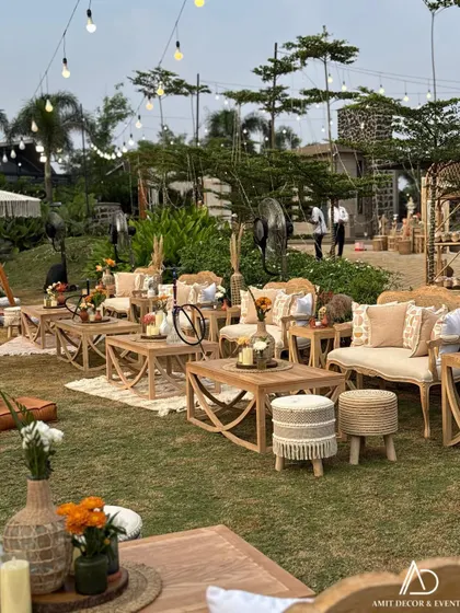 A wider view of the boho seating arrangement, showing the combination of sofas, low tables, and stools that create a comfortable and stylish lounge space.