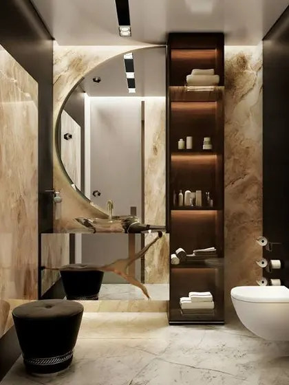 A high-contrast, luxurious bathroom with dark walls, gold-veined marble, and a tall, back-lit storage unit. The round mirror and stool add a soft touch to the bold design.