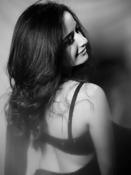 The back view of the black saree gown reveals the simple, elegant lines of the blouse, making it a versatile and timeless piece.