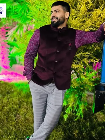 This client pairs a custom-fit velvet Nehru jacket in a deep wine color with a printed shirt, showing how to style my pieces for a festive occasion.