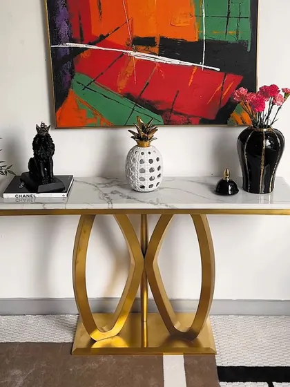 The same console table, styled differently to show its versatility. Here, the arrangement is more asymmetrical, creating a dynamic and modern feel.