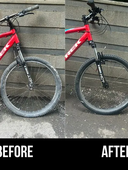 The front view of a red Trek MTB before and after our service. We replaced the worn tyre and cleaned the entire front assembly, including the suspension forks.