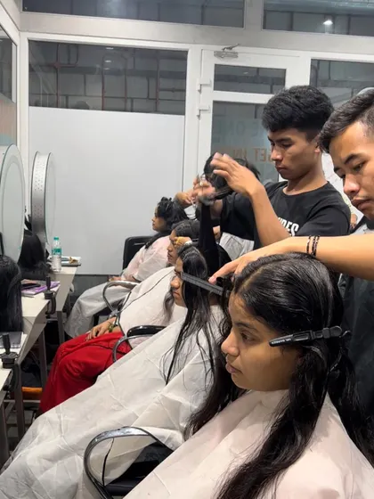 Our hair students get valuable hands-on experience working on real models during a busy haircutting session.