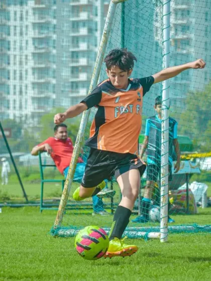 A player takes a shot on goal, aiming for the back of the net in a crucial match moment.
