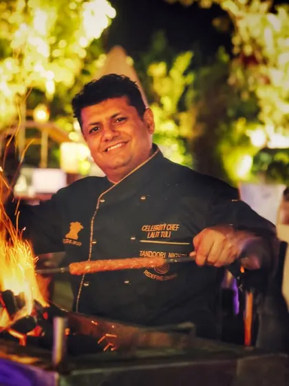 Our celebrity chef, Lalit Tuli, is seen here grilling kebabs over open flames, showcasing the passion and expertise that is the foundation of Tandoori Nights.