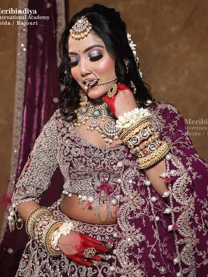 This image shows the detailed work of the bridal hairstyle, combining a voluminous updo with a long, flower-adorned braid.