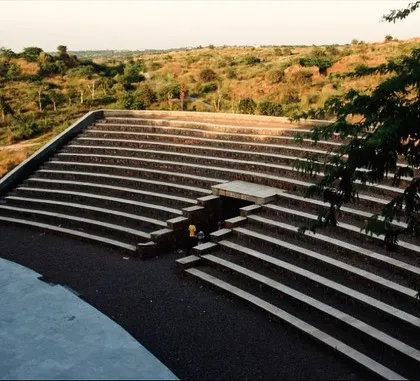 This amphitheater at the Aravali Biodiversity Park is an example of large-scale public landscape design that respects its environment. Built into the natural contours of the land using locally sourced stone, it serves as a community gathering space that feels like an organic extension of the terrain.