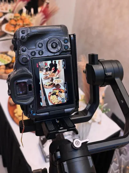 A behind-the-scenes look at a photoshoot for Arte Salon. A professional camera on a gimbal is set up to capture the beauty of the grazing table from every angle.