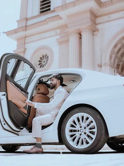 The groom stepping out of a luxury car, ready for his church wedding.