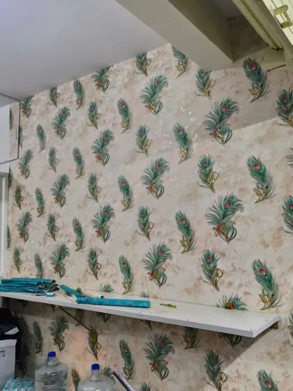A wider view of the peacock feather wallpaper, showing the repeating pattern.