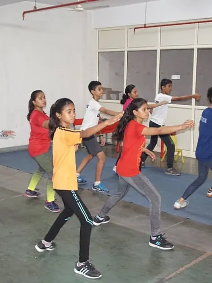 Young fencers practice their form in a line. Repetition and attention to detail are key as we build a strong technical foundation from the very beginning.