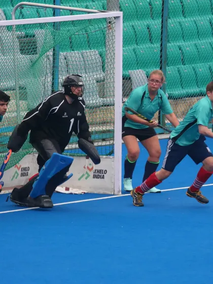 Defensive action right in front of the goal. My goalkeeper and defenders work together to block a scoring attempt from the opposition.