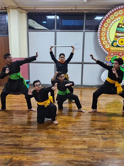 A group of my junior students striking a dynamic pose from a Chhau warrior sequence. Training starts at a young age to build strength and flexibility.