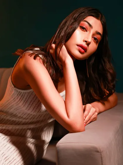 A relaxed and intimate portrait with warm, moody lighting. This type of shot shows a softer, more contemplative side, adding emotional depth to a portfolio.