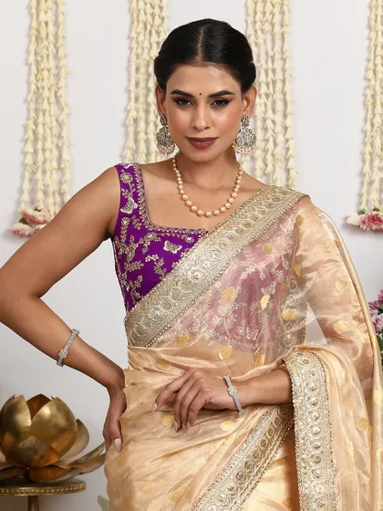 A close-up of the sleeveless purple blouse, showing the intricate embroidery and the beautiful fit.