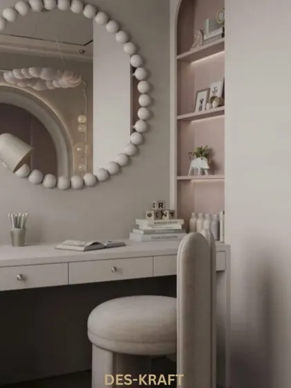 The study nook is both stylish and functional, with a simple white desk, a comfortable chair, and built-in shelving with a soft pink interior.