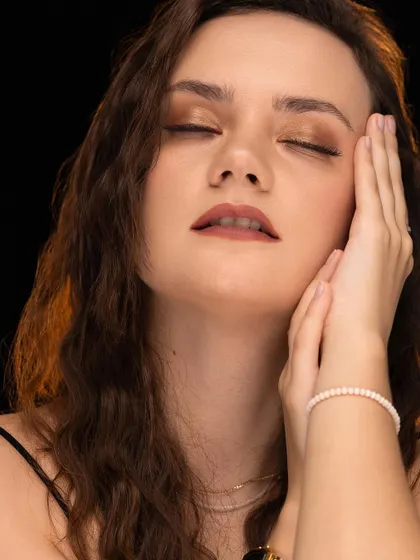 An expressive shot with closed eyes, conveying a sense of peace and serenity. This adds emotional range to a portfolio, showing more than just standard poses.