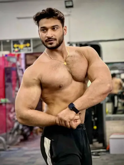 Gains. A confident shirtless pose showing my physique.