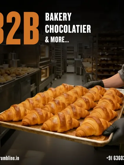 Rows of croissants fill a baking tray in our business-supply catalogue, with a chef holding the batch.