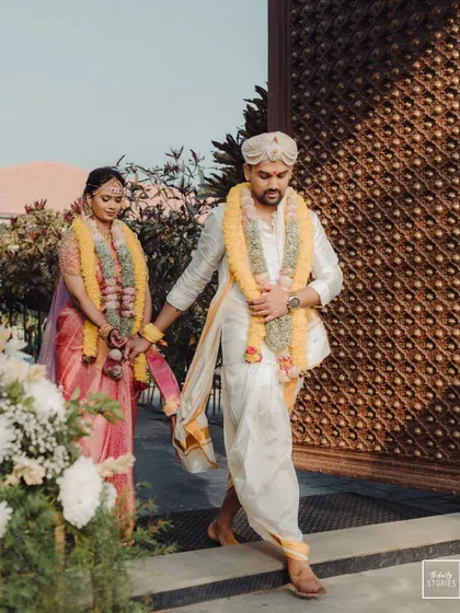 The couple walking hand-in-hand from the mandap. This shot captures the beginning of their new journey together, framed by the beauty of their venue.