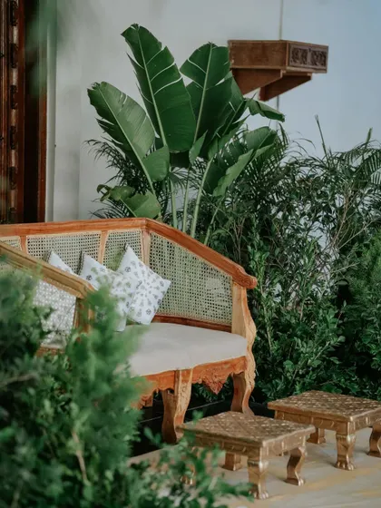 Sometimes, the best decor works with the venue's natural beauty. For this Haldi, we used the venue's vintage door as a focal point and added lush greenery to create a simple, elegant, and nature-inspired backdrop.