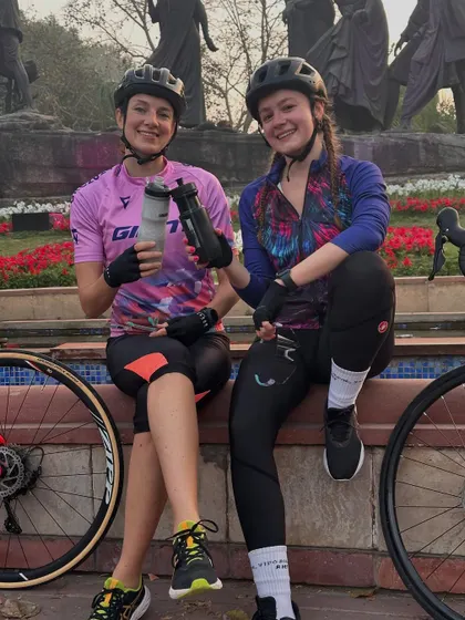 Two friends enjoying a post-ride chat and hydration break.