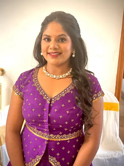 Dr. Meghana for her housewarming ceremony. A simple, elegant look with soft curls and a pearl necklace, perfect for hosting a special event at home.