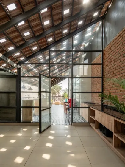 The redesigned terrace opens up to the outdoors, with large glass doors connecting the interior gym and cafeteria to the open-air seating area.