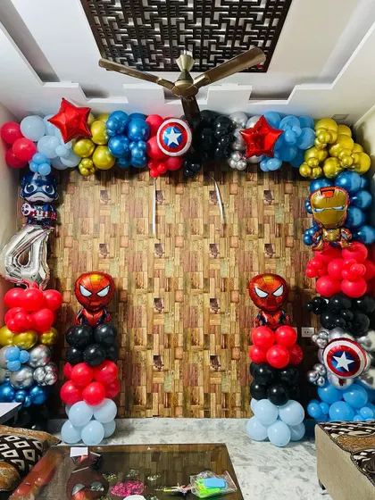 An action-packed superhero birthday party. This balloon arch is packed with characters like Spider-Man, Captain America, and Iron Man, using a classic red, blue, and black color scheme.