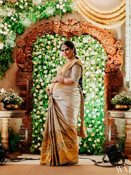 A full-length shot of me against the beautiful floral backdrop of my baby shower.
