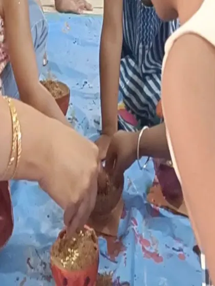 Children add the finishing touches to their painted coconut shells, a unique and eco-friendly craft idea.