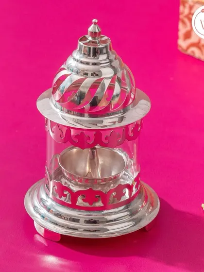 A silver Akhand Diya (lantern), another traditional and meaningful gift that symbolizes light and positivity.