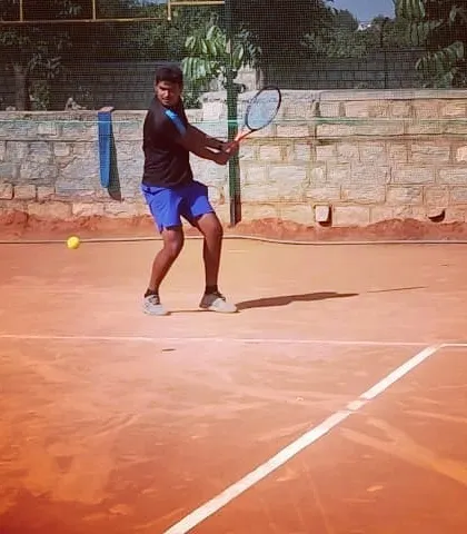 A male competitor hits a strong forehand during a match at the Tennis360 Open Tournament.
