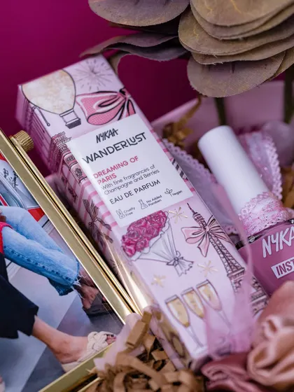 A close-up of the pampering products in the friendship hamper, including Nykaa perfume and nail polish.