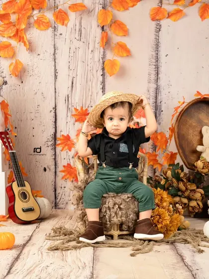 This little guy is trying on his hat, a cute and candid moment from the shoot.