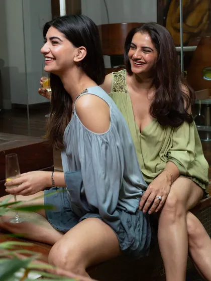 A happy, candid moment captured between two models, showcasing the relaxed fit and feel of the Beachbum dresses. These images tell a story and make the apparel feel more accessible.