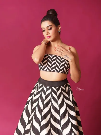 A closer look at the black and white chevron print outfit. The tube top and high-waisted skirt create a clean, modern silhouette.