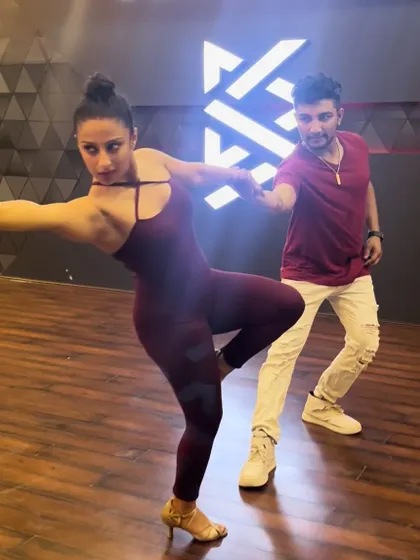 Striking a pose during a Bachata routine. We love incorporating dynamic and visually appealing moves into our choreography to keep things exciting.