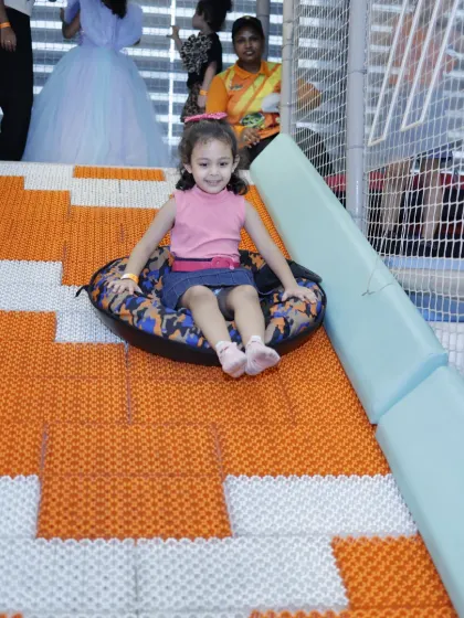 All smiles on the doughnut slide. We ensure our staff is always on hand to help kids get situated for a safe and fun ride every time.