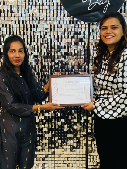 Another happy graduate receiving her framed certificate. We believe in celebrating the hard work and dedication of every student.