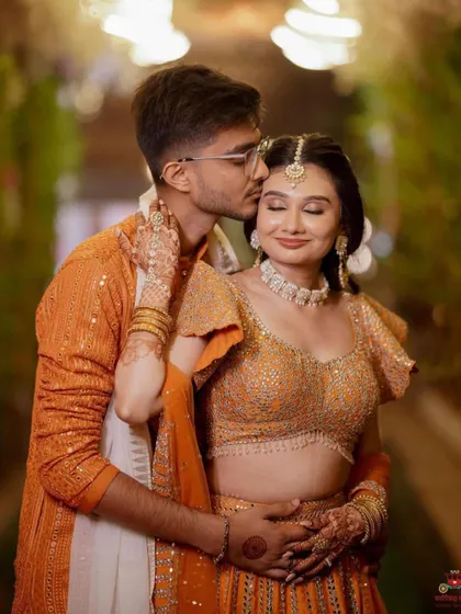 A romantic portrait from the Haldi event. The bride's makeup is soft and luminous, with a focus on her eyes that are sparkling with happiness.