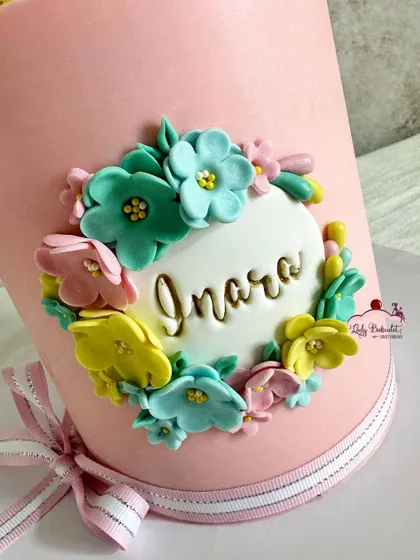 A detailed shot of the floral name plaque, with each tiny flower carefully placed.
