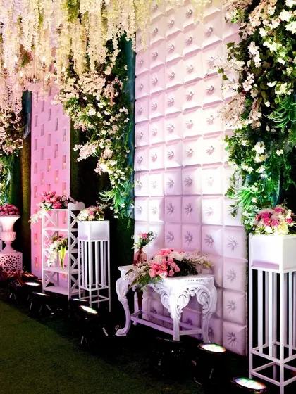 Another angle of the dreamy entrance, with textured walls and floral arrangements creating a layered and sophisticated look.