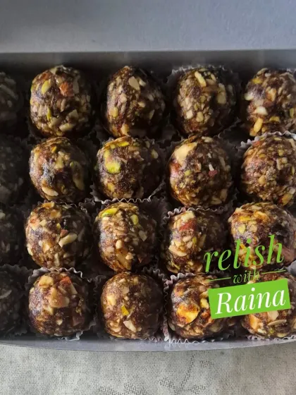 A box of my Dry Fruit Laddoos, showing the dark, rich color from the black dates I use as a natural sweetener.