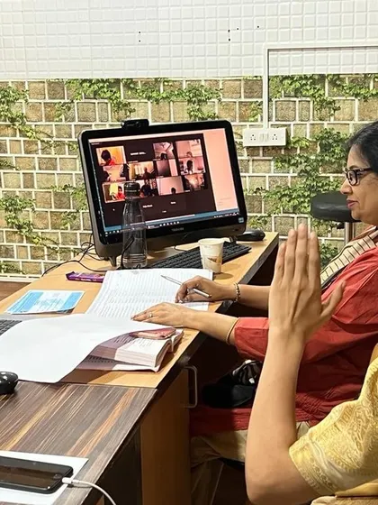 Examiners conducting an online practical exam, interacting with students via video call to assess their performance.
