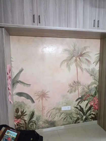 A soft, pink-toned tropical mural installed in a bedroom nook.