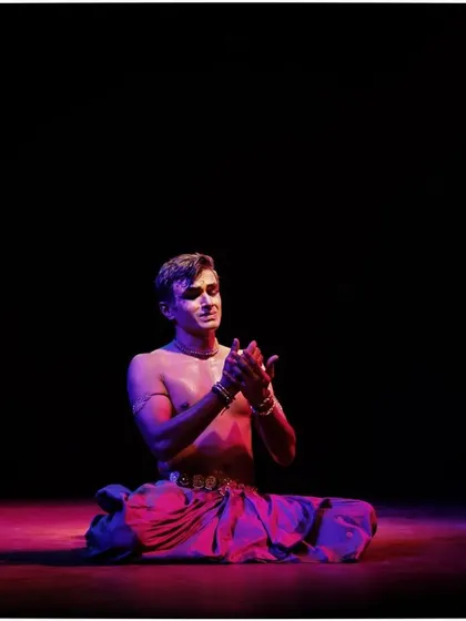 A moment of quiet contemplation during a solo recital. The performance is not just about movement, but also about finding stillness and emotion.