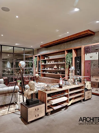 This image showcases an office interior we designed, featured in Architect and Interiors India. The space uses a mix of raw and refined materials, including wood, concrete, and vintage-style furniture, to create an eclectic and inspiring work environment.