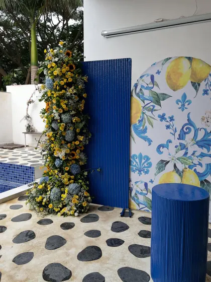 We brought a slice of the Amalfi Coast to Bangalore for this 40th birthday. The decor features a vibrant blue and yellow color scheme, custom lemon-print backdrops, and lush floral arrangements with sunflowers and hydrangeas for a fresh, summery feel.