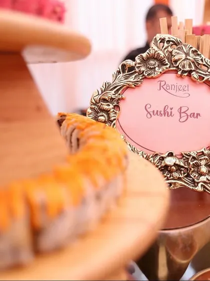 Our culinary offerings extend far beyond traditional Indian cuisine. This elegant live Sushi Bar, complete with an ornate sign, showcases our expertise in crafting authentic and sophisticated global food experiences for weddings.